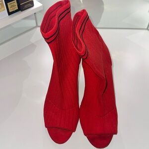 Red ankle booties with 2 small black stripes around me the top.